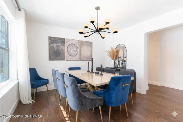 a view of a dining room with furniture wooden floor and chandelier