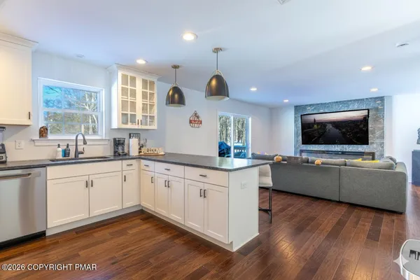 a large white kitchen with a large window