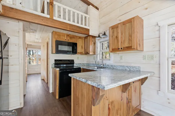 a kitchen with stainless steel appliances granite countertop a stove and a sink