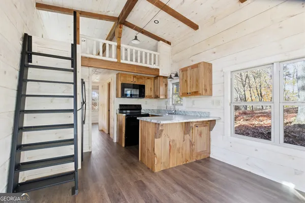 a view of an entryway with wooden floor