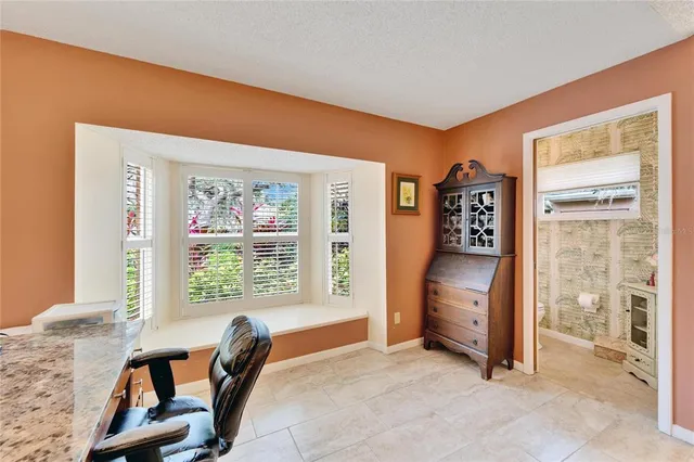 a kitchen with white cabinets and appliances
