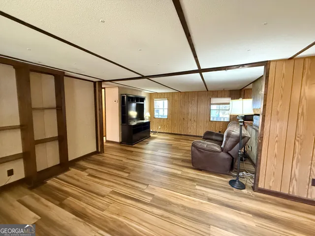 a living room with a couch and wooden floor