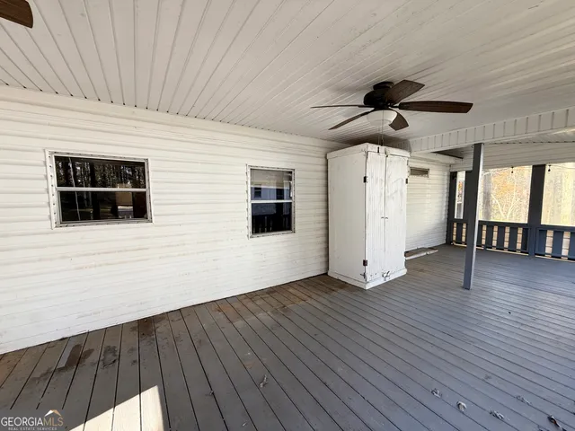 a view of a house with a yard and deck