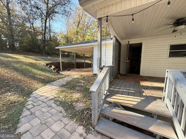 front view of a house with a yard and balcony