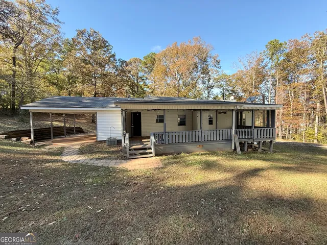 a view of large tree in front of house