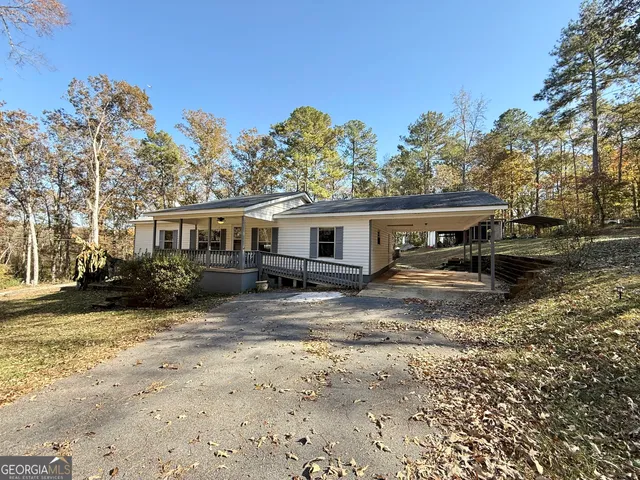 a view of a house with a yard and sitting area