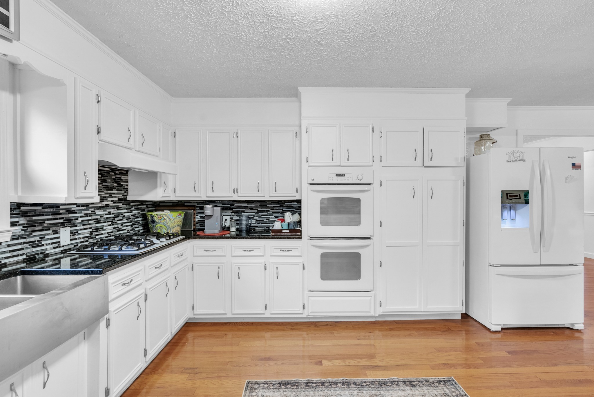 1389 Coconut Ridge Road Smithville, TN 37166 - Photo 13 of 39 a kitchen with white cabinets and white appliances