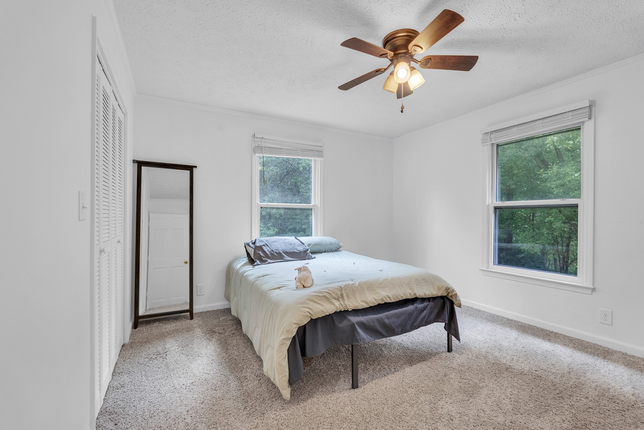 1389 Coconut Ridge Road Smithville, TN 37166 - Photo 26 of 39 a bed sitting in a bedroom next to a window