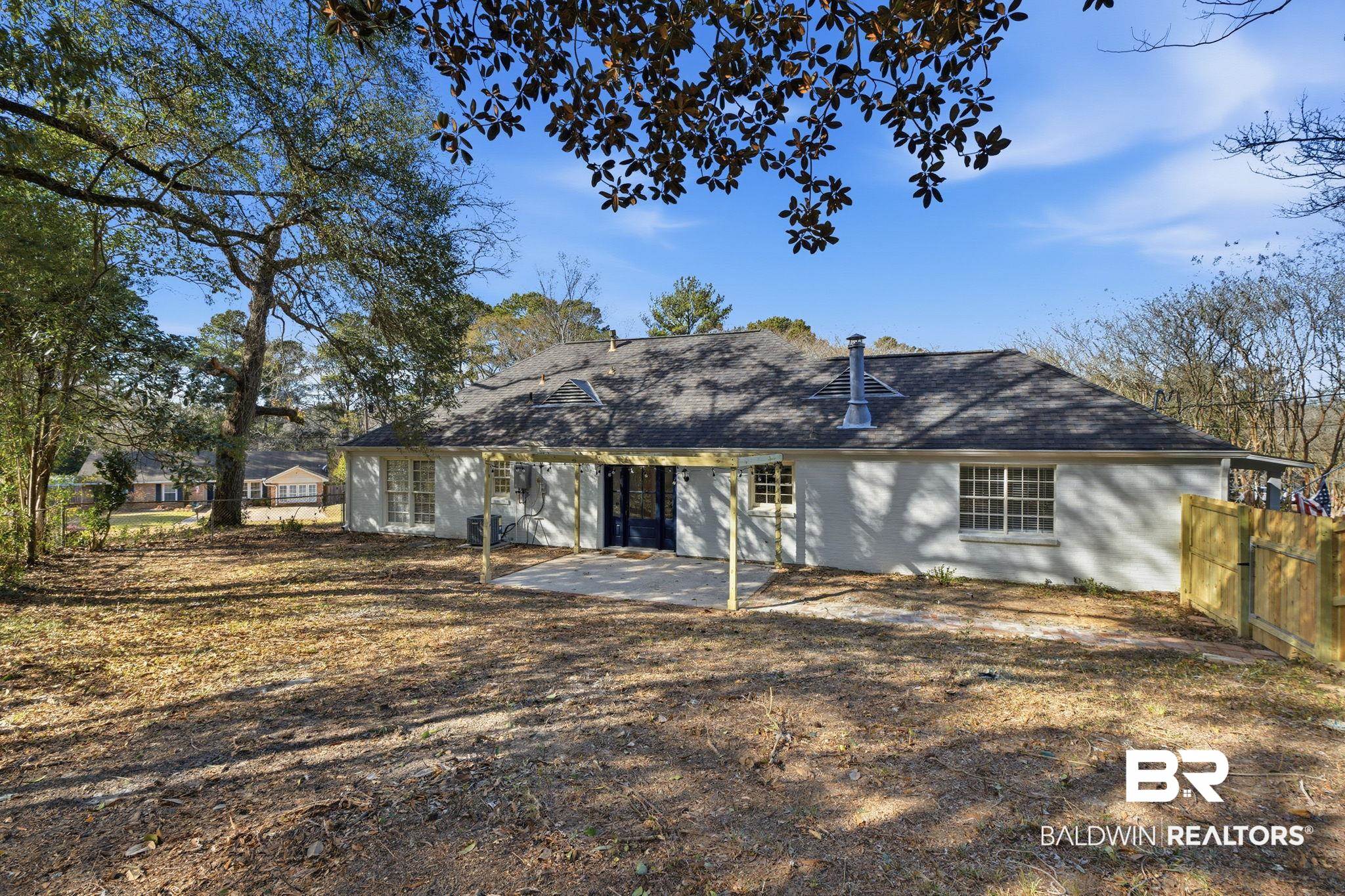 814 Nassau Drive Mobile, AL 36608 - Photo 35 of 44 Back of house with a fenced backyard and a shingled roof