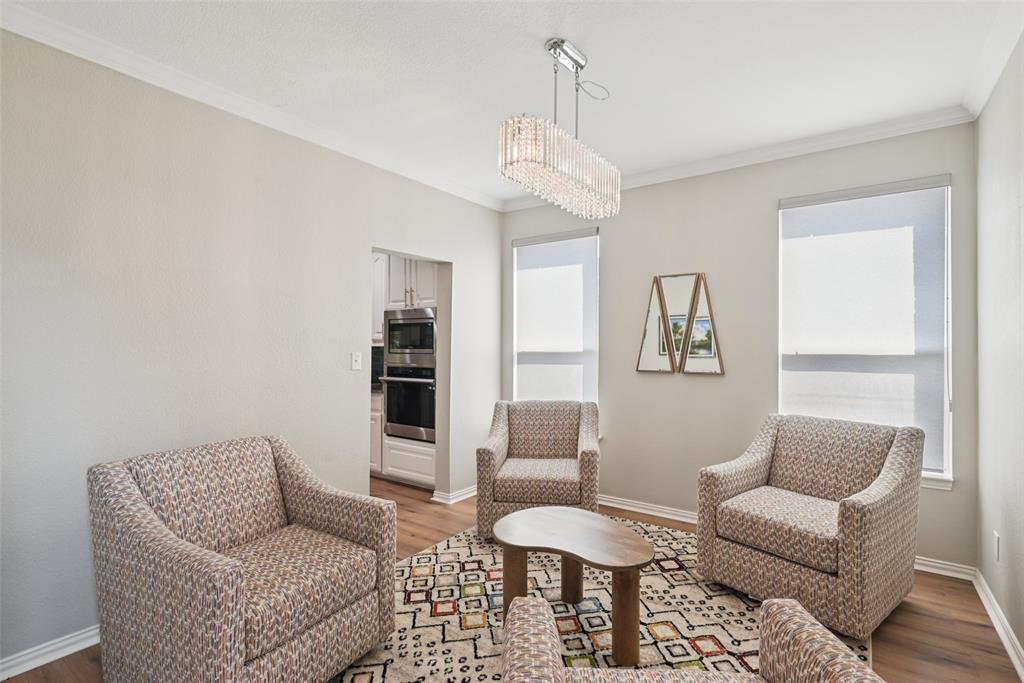1321 Shell Beach Drive Little Elm, TX 75068 - Photo 14 of 40 a living room with furniture a chandelier and a rug