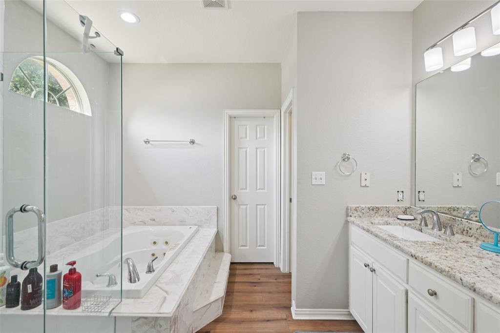 1321 Shell Beach Drive Little Elm, TX 75068 - Photo 18 of 40 a bathroom with a granite countertop tub sink and shower