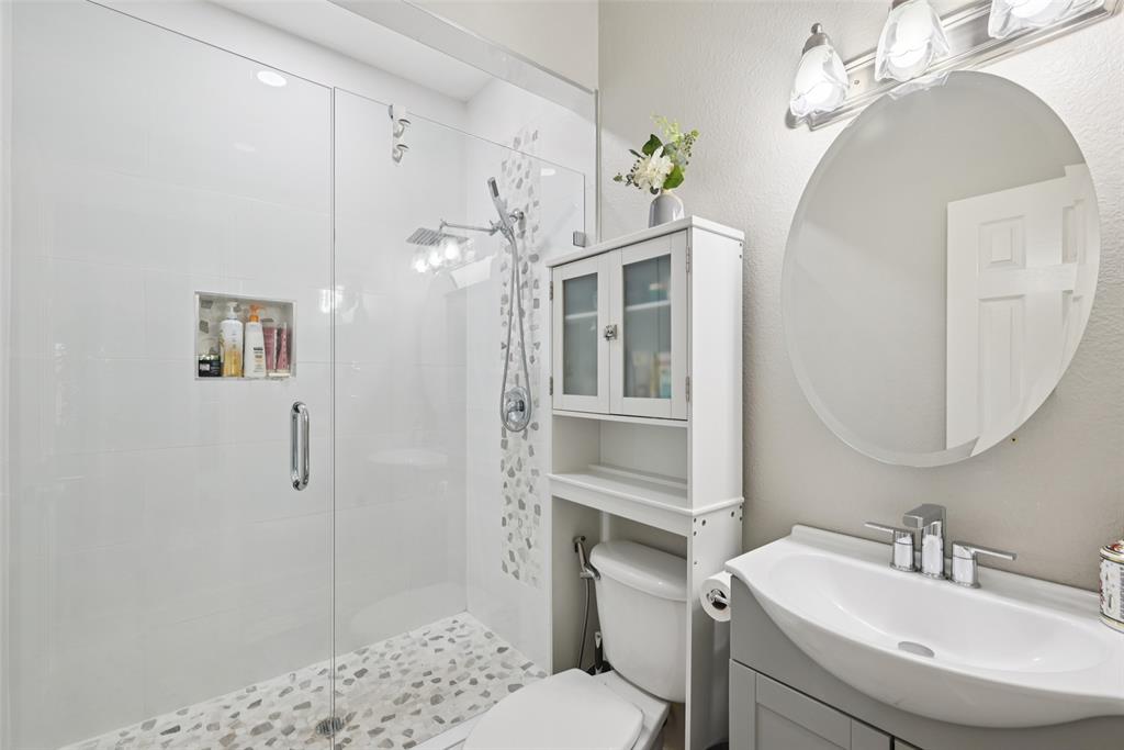 1321 Shell Beach Drive Little Elm, TX 75068 - Photo 22 of 40 a bathroom with a sink a toilet and shower
