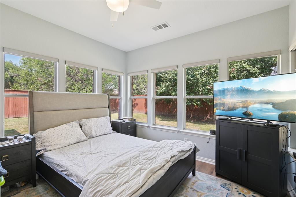 1321 Shell Beach Drive Little Elm, TX 75068 - Photo 23 of 40 a bedroom with a bed and large window