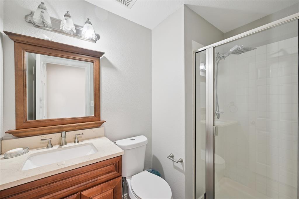 1321 Shell Beach Drive Little Elm, TX 75068 - Photo 26 of 40 a bathroom with a granite countertop sink toilet and shower