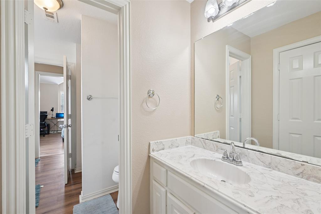 1321 Shell Beach Drive Little Elm, TX 75068 - Photo 28 of 40 a bathroom with a granite countertop sink and a mirror