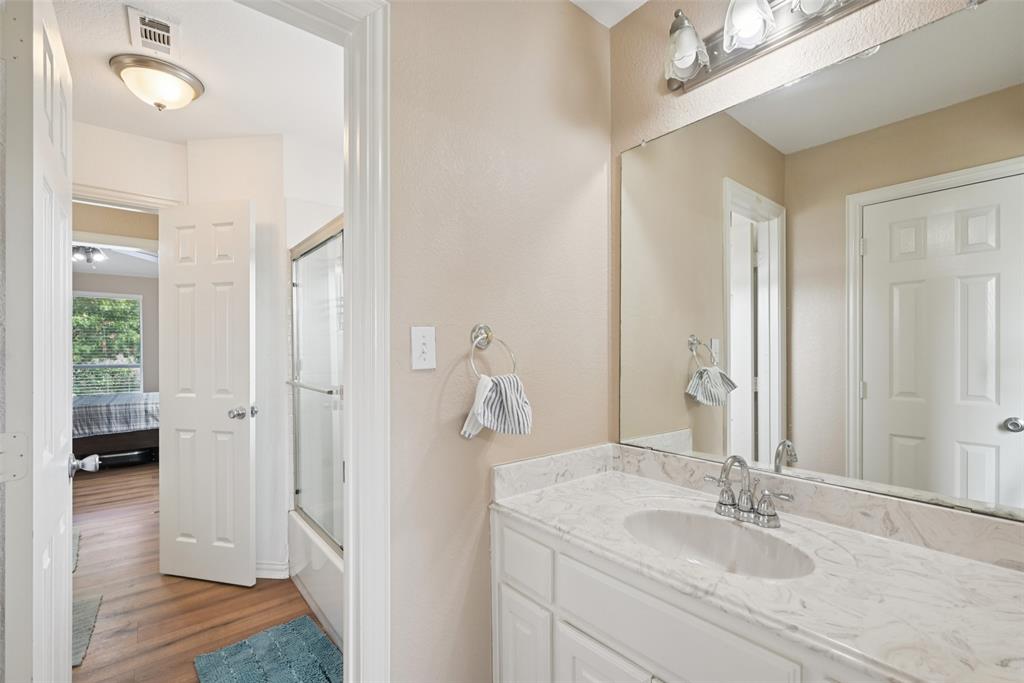 1321 Shell Beach Drive Little Elm, TX 75068 - Photo 31 of 40 a en suite bathroom with a sink and a mirror
