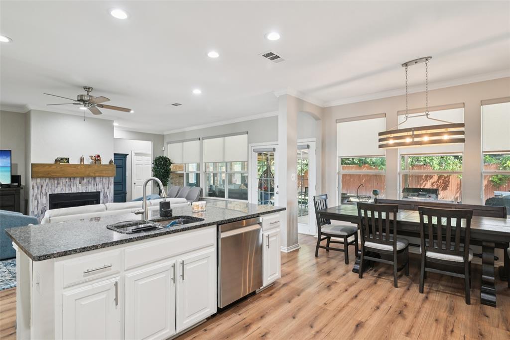 1321 Shell Beach Drive Little Elm, TX 75068 - Photo 9 of 40 a kitchen with sink a table and chairs