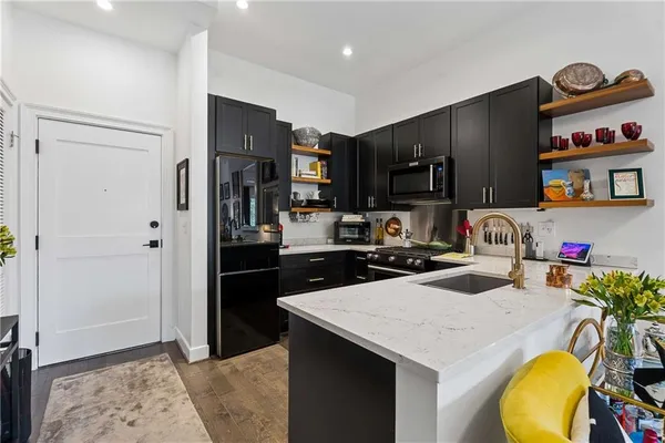 a kitchen with a sink a stove and refrigerator