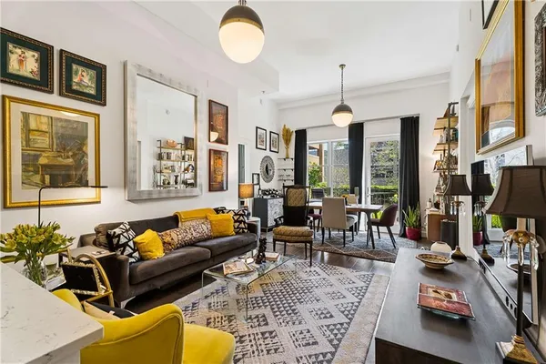 a living room with furniture a rug and a chandelier