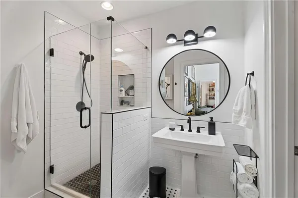 a bathroom with a sink a toilet and a mirror