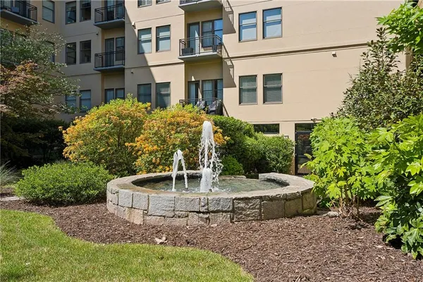 a yellow building sitting in middle of the middle of the garden