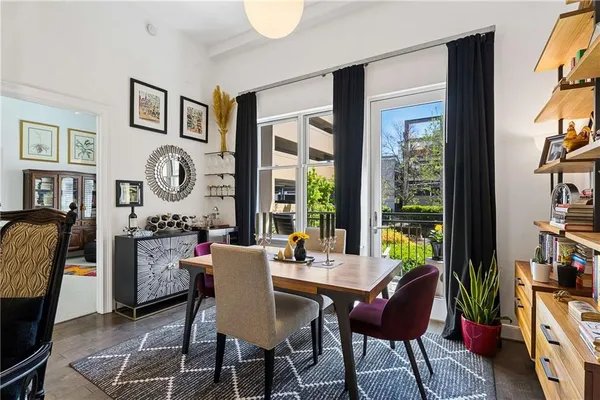 a dining room with furniture and a large window
