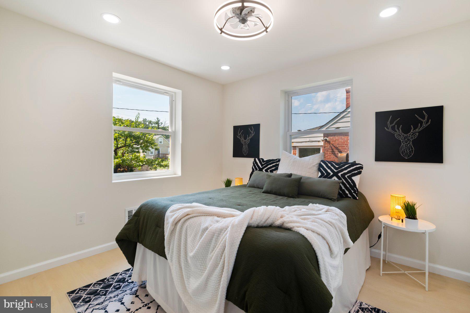 5302 The Alameda Baltimore, MD 21239 - Photo 15 of 36 a bedroom with a bed and a chandelier