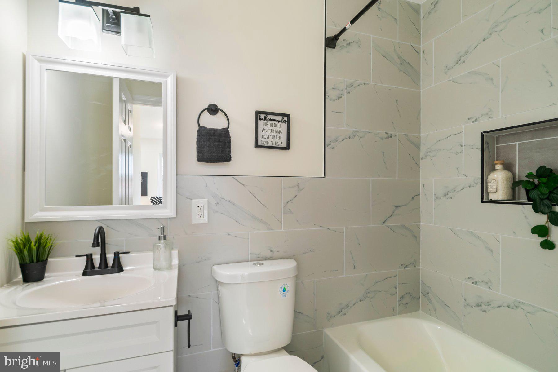 5302 The Alameda Baltimore, MD 21239 - Photo 17 of 36 a bathroom with a sink toilet and shower