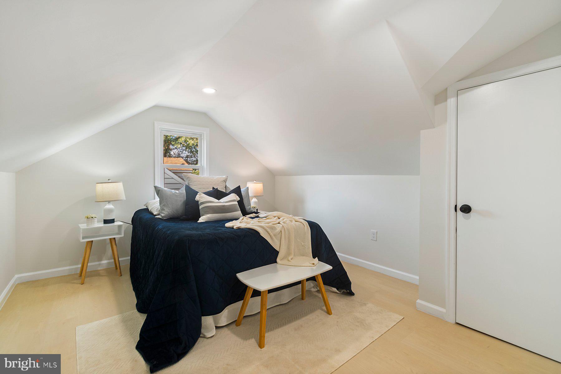 5302 The Alameda Baltimore, MD 21239 - Photo 22 of 36 a bedroom with a bed and a table in it