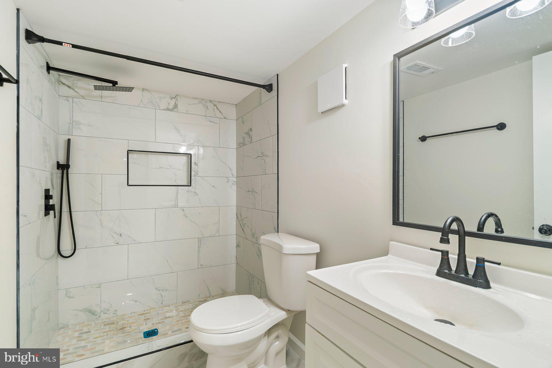 5302 The Alameda Baltimore, MD 21239 - Photo 27 of 36 a bathroom with a shower a toilet and sink