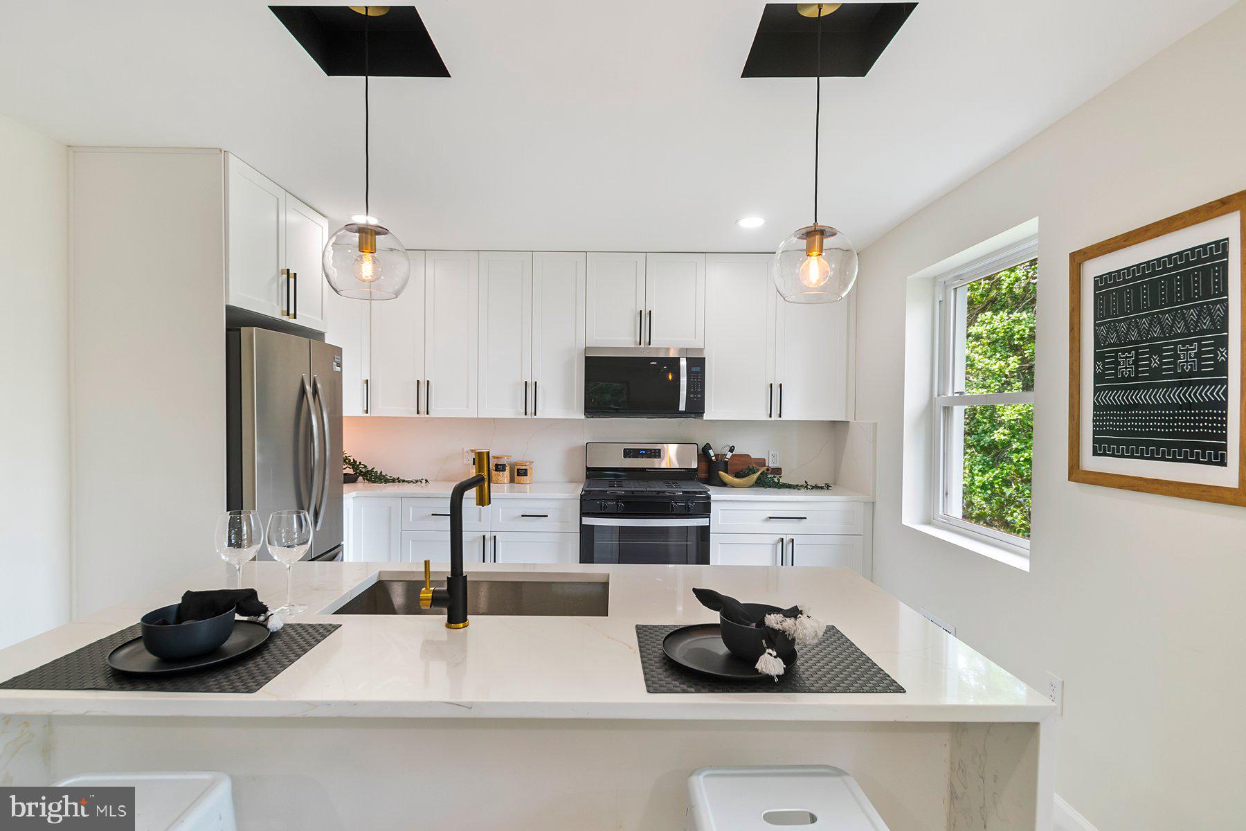 5302 The Alameda Baltimore, MD 21239 - Photo 6 of 36 a kitchen with a sink a counter and cabinets