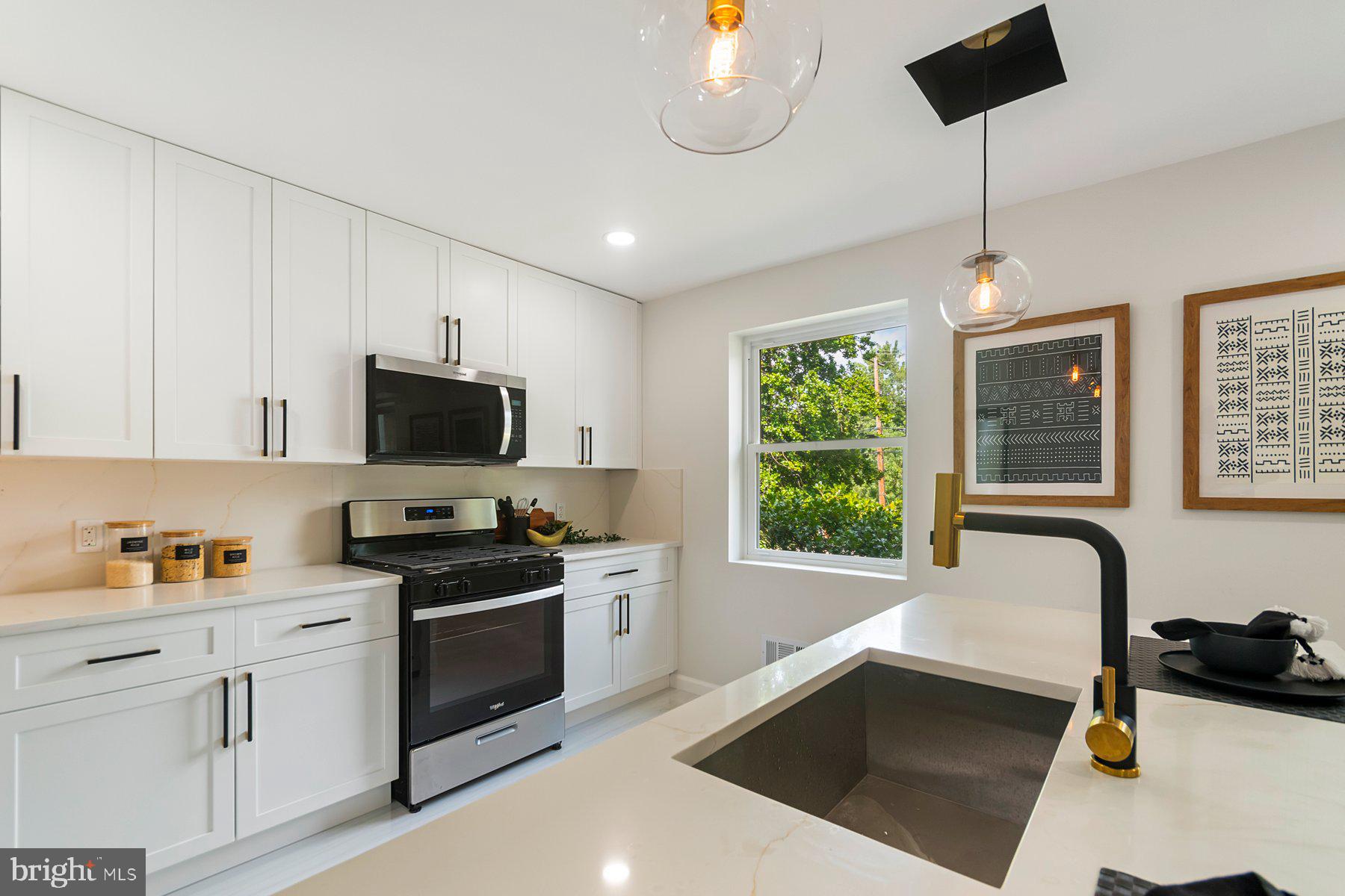 5302 The Alameda Baltimore, MD 21239 - Photo 7 of 36 a kitchen with stainless steel appliances a stove a sink a microwave a refrigerator and cabinets
