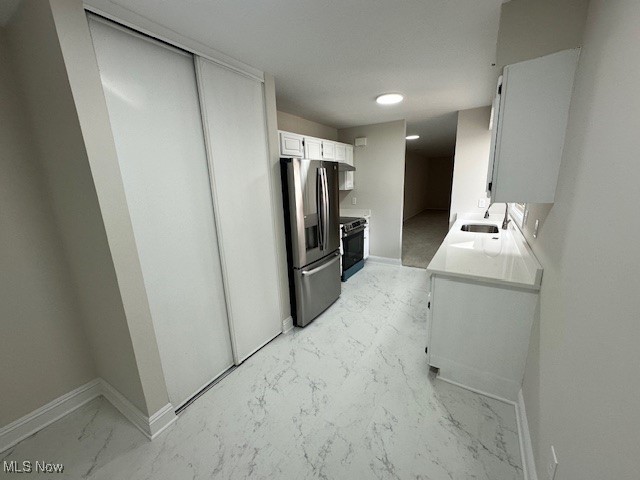 16575 Wren Road, Unit 3F Chagrin Falls, OH 44023 - Photo 3 of 14 Kitchen with sink, stainless steel fridge with ice dispenser, white cabinets, and black / electric stove