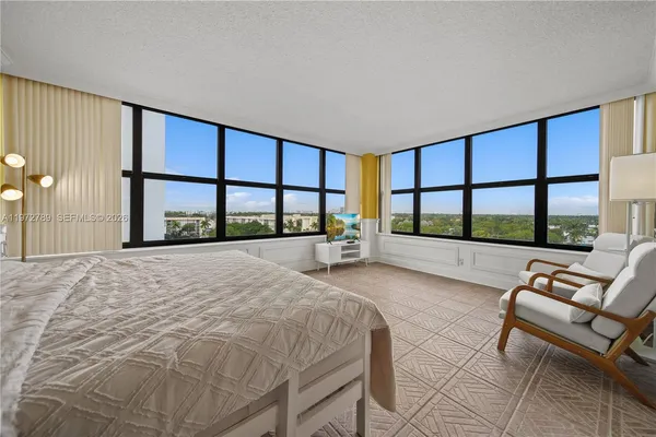 a bedroom with a bed and large window