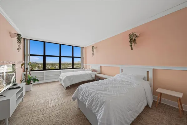 a bed room with two beds and a balcony