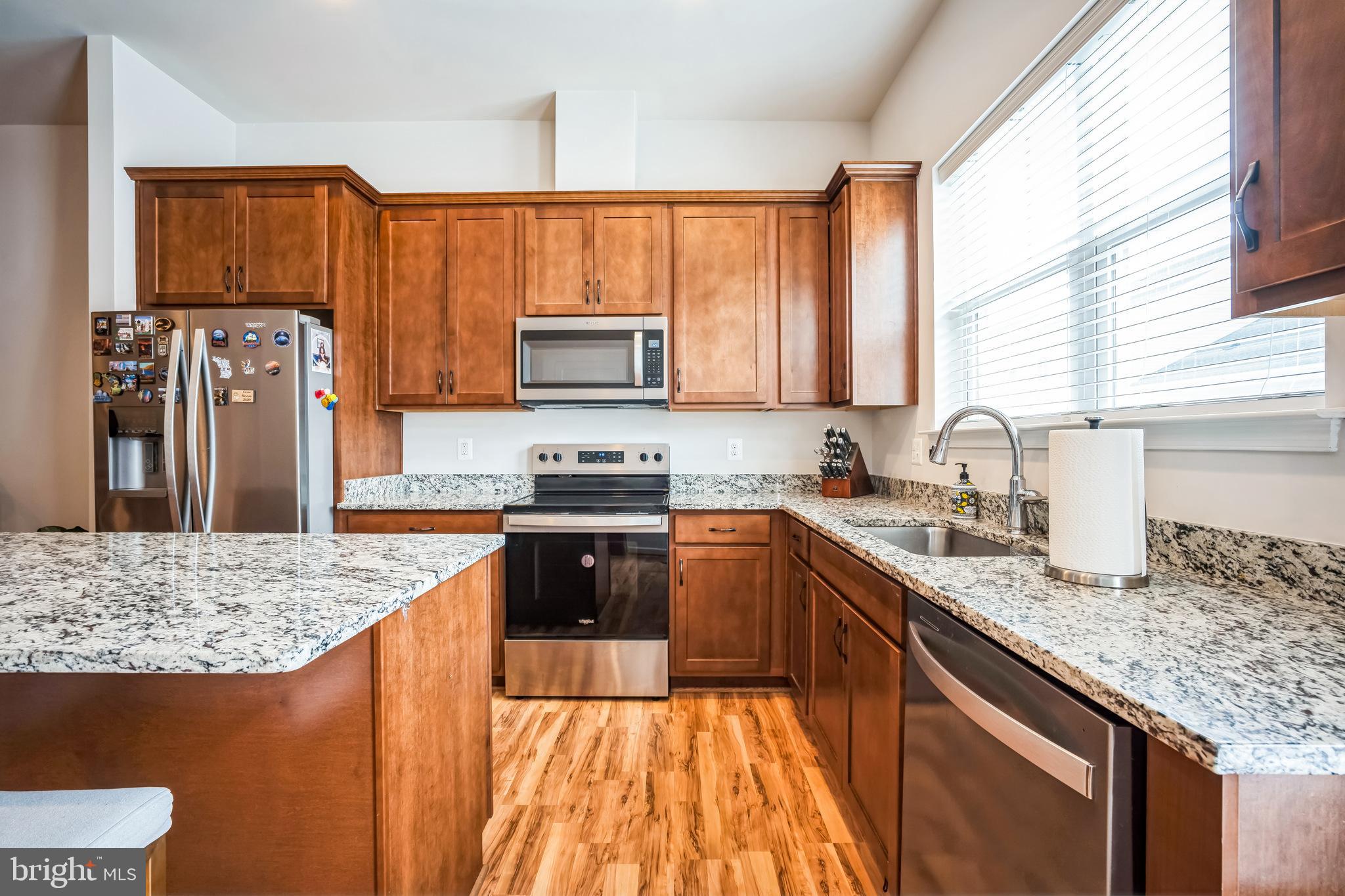 9348 Crestview Rdg Drive Bristow, VA 20136 - Photo 11 of 29 a kitchen with stainless steel appliances granite countertop a stove a sink dishwasher and a refrigerator