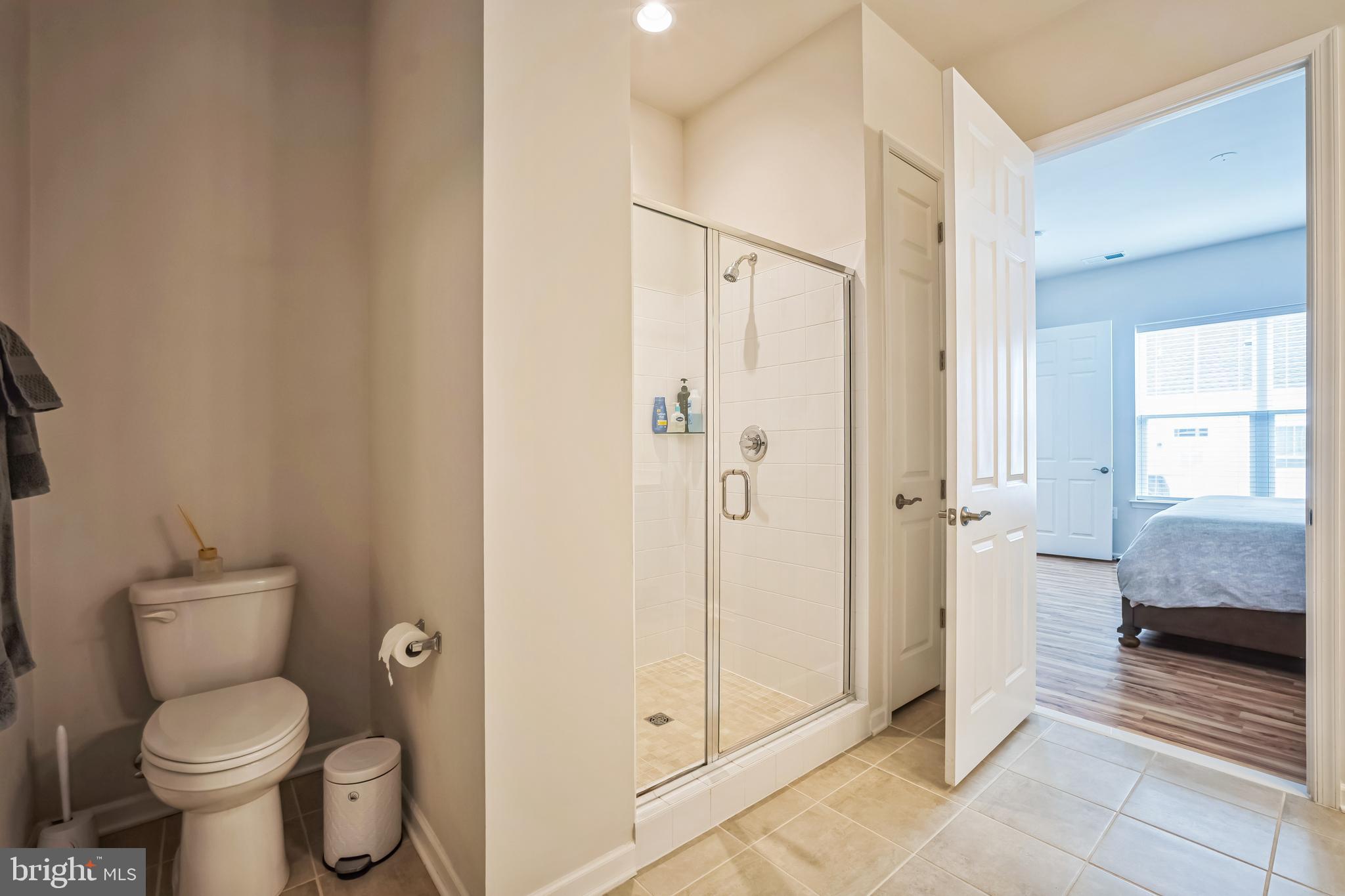 9348 Crestview Rdg Drive Bristow, VA 20136 - Photo 19 of 29 a bathroom with a granite countertop toilet and a shower