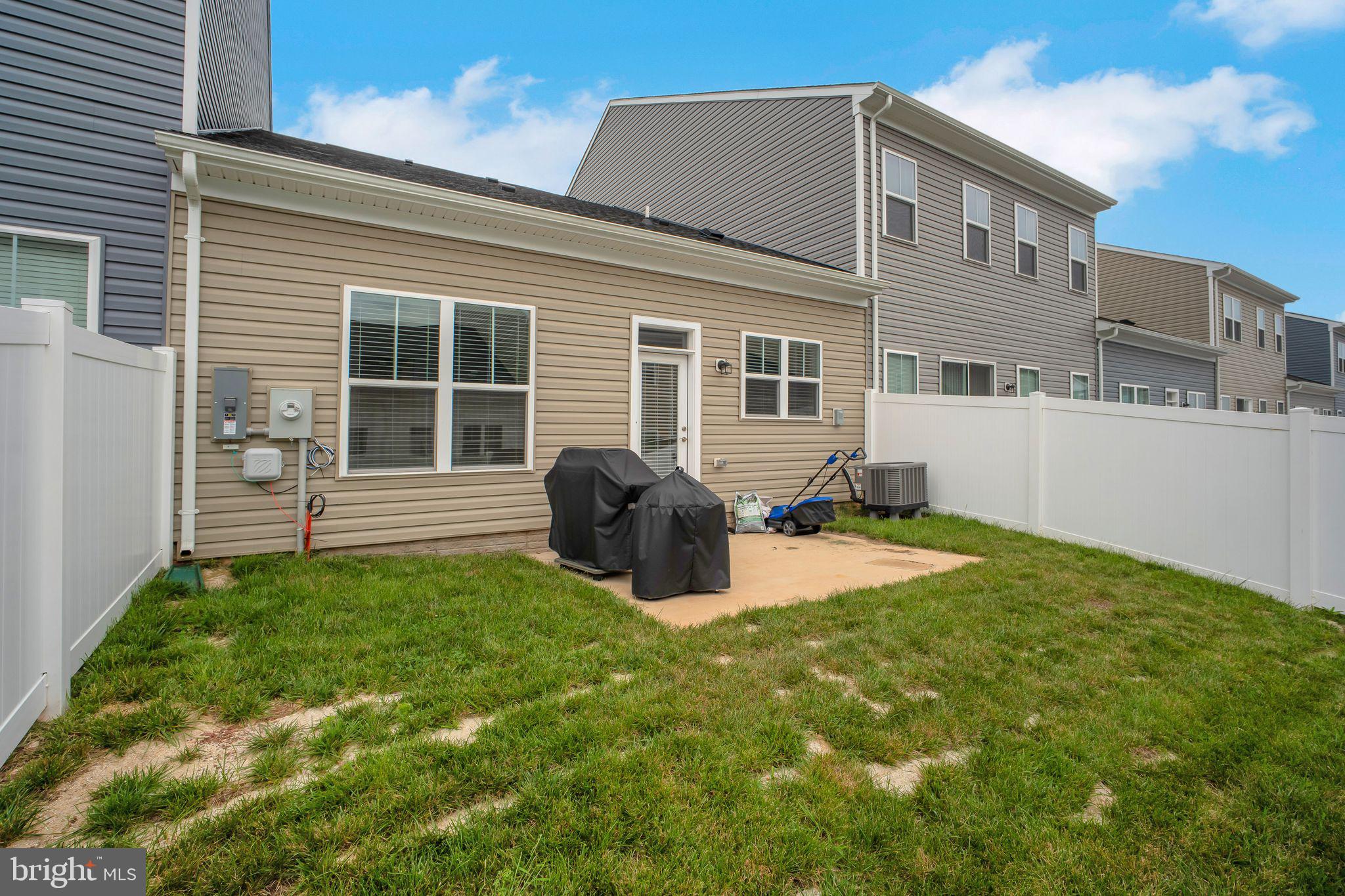 9348 Crestview Rdg Drive Bristow, VA 20136 - Photo 28 of 29 a backyard of a house with table and chairs