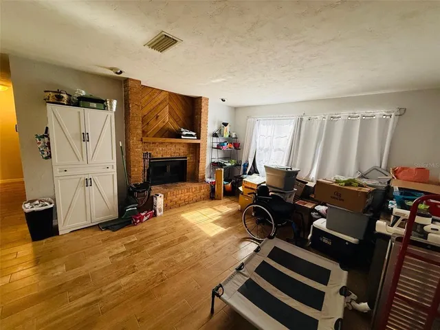 a view of a livingroom with furniture and a fireplace