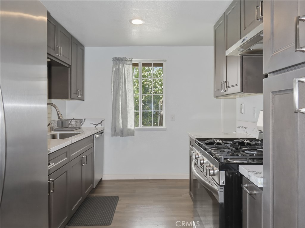 4409 Challen Avenue Riverside, CA 92503 - Photo 13 of 31 a kitchen with cabinets appliances and a window