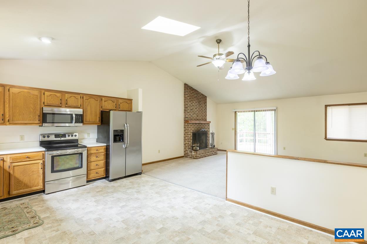 32 Begum Road Palmyra, VA 22963 - Photo 4 of 23 a view of a kitchen with a sink and dishwasher a refrigerator with wooden floor