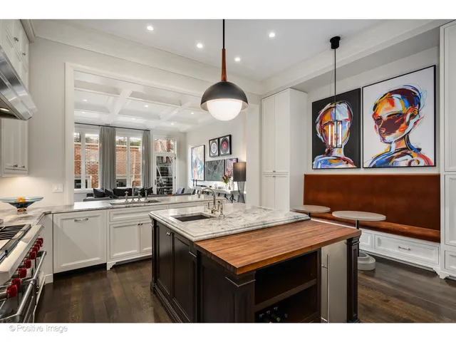 a kitchen with stainless steel appliances granite countertop a stove a sink dishwasher and cabinets with wooden floor