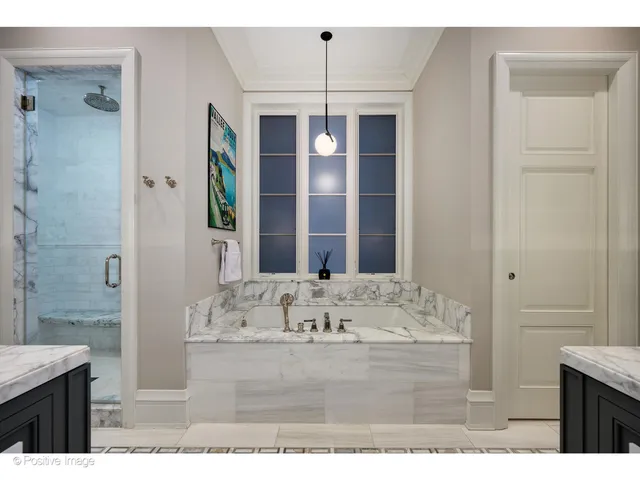 a bathroom with a granite countertop double vanity sink and a mirror