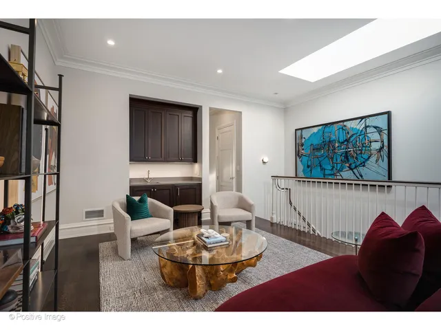 a living room with furniture and a painting