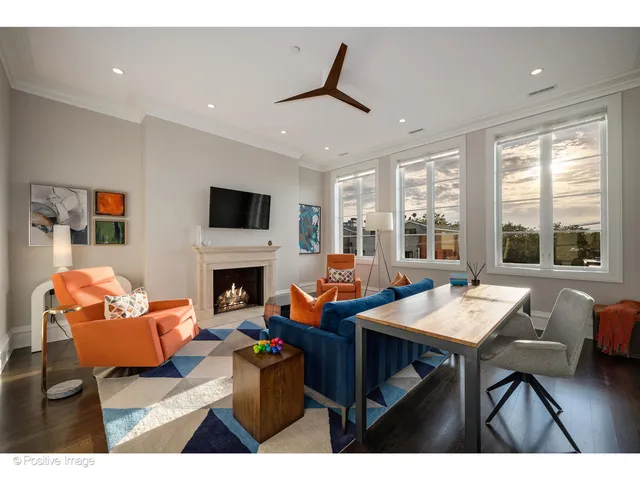 a living room with furniture a rug and a large window