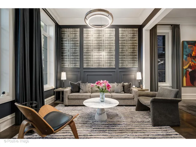 a living room with furniture and floor to ceiling windows