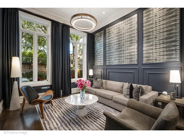 a living room with furniture and floor to ceiling windows