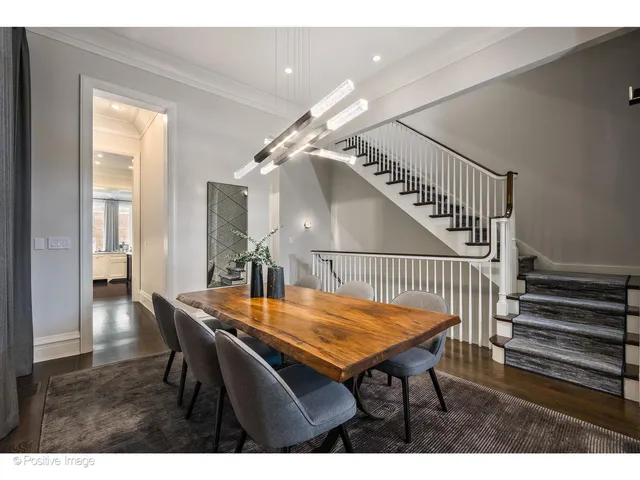 a dining room with furniture and wooden floor