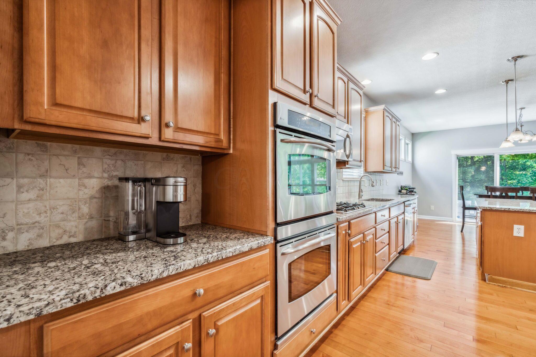 219 Smokewood Road Powell, OH 43065 - Photo 11 of 59 Granite countertops, island, walk-in pantry, single basin sink, gas top range, double wall ovens and built-in wine fridge!