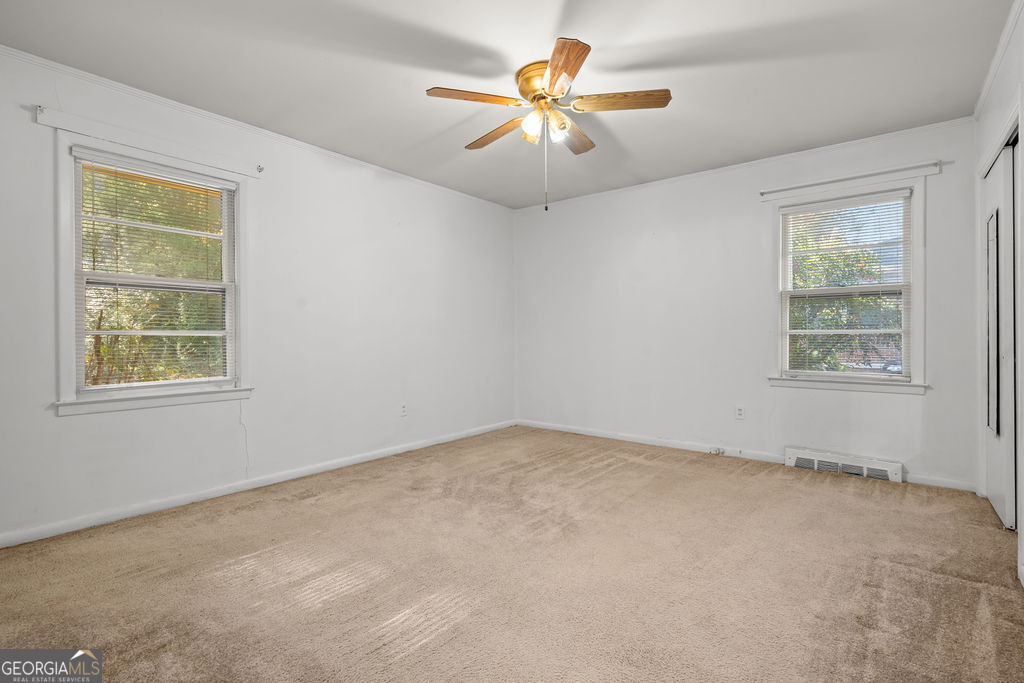 130 Club Drive Stockbridge, GA 30281 - Photo 15 of 28 an empty room with windows and fan